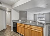 Thumbnail 3 of 40 - Kitchen with breakfast bar, double sink, dishwasher, and ample counter space in a 3-bedroom, 2-bath apartment at Gregory Cove in Jacksonville, FL.