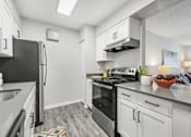 Thumbnail 4 of 40 - a kitchen with stainless steel appliances and white cabinets