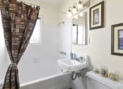 Thumbnail 16 of 20 - a bathroom with a sink and a bath tub