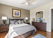 Thumbnail 12 of 20 - a bedroom with a bed and a ceiling fan