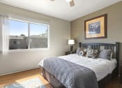 Thumbnail 11 of 20 - a bedroom with a large bed and two windows