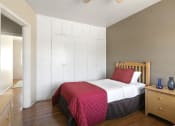 Thumbnail 15 of 20 - a bedroom with a bed with a red blanket