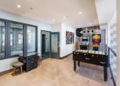 Thumbnail 16 of 25 - a games room with a foosball table and a video game system