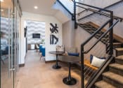 Thumbnail 9 of 25 - a living room with a staircase and a glass door
