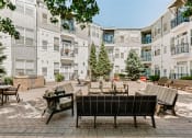 Thumbnail 17 of 25 - our apartments offer a spacious courtyard with furniture and tables