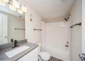 Thumbnail 24 of 40 - Bathroom with a sink and a toilet and a tub  at Avery Park in Englewood, CO