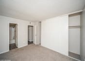 Thumbnail 19 of 40 - Bedroom with white walls and closet doors  at Avery Park in Englewood, CO