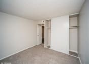 Thumbnail 21 of 40 - Bedroom with white walls and a closet  at Avery Park in Englewood, CO