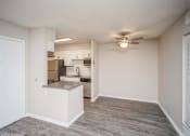 Thumbnail 16 of 40 - Living room and kitchen with a ceiling fan  at Avery Park in Englewood, CO