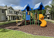 Thumbnail 2 of 17 - A playground with a yellow slide and blue canopies.