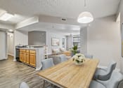 Thumbnail 2 of 44 - A dining room with a wooden table and grey chairs.