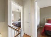 Thumbnail 10 of 20 - a bedroom with a bed and a mirrored closet