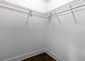 Thumbnail 8 of 18 - the closet in a bedroom with white walls and metal shelves