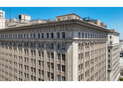 Thumbnail 18 of 18 - a tall building with many windows and a blue sky