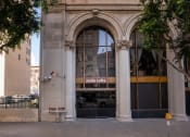 Thumbnail 15 of 18 - the facade of a building with a glass door and an arched doorway