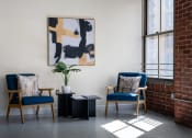 Thumbnail 10 of 18 - two chairs and a table in a room with a brick wall