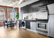 Thumbnail 1 of 18 - a kitchen with stainless steel appliances and a large window