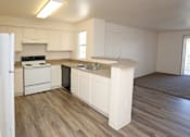 Thumbnail 7 of 26 - Open kitchen with white appliances at Canon de Arrowhead in Albuquerque, New Mexico