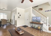 Thumbnail 7 of 20 - a living room with a television and a staircase