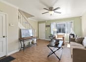 Thumbnail 4 of 20 - a living room with a couch and a ceiling fan
