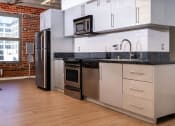 Thumbnail 13 of 21 - a kitchen with white cabinets and a stainless steel refrigerator