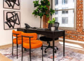 Thumbnail 8 of 21 - desk with two orange chairs against a brick wall