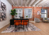 Thumbnail 5 of 21 - an office with a brick wall and a desk in front of a window