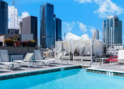 Thumbnail 19 of 21 - a pool on the roof of a building with skyscrapers in the background