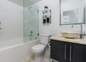 Thumbnail 16 of 21 - a bathroom with a toilet and a shower and a sink