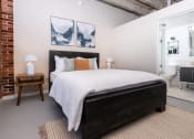 Thumbnail 11 of 21 - a bedroom with a bed and a bathroom