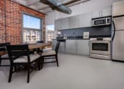 Thumbnail 4 of 21 - a kitchen with a table and chairs and a refrigerator