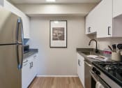 Thumbnail 11 of 61 - Galley style kitchen with chic white cabinets