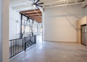 Thumbnail 31 of 57 - the lobby of a building with a concrete floor and white walls