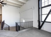Thumbnail 33 of 57 - the stairway in the lobby of a building with a garage door