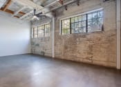 Thumbnail 39 of 57 - an empty room with a brick wall and a large window