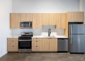 Thumbnail 40 of 57 - a kitchen with wooden cabinets and stainless steel appliances