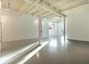 Thumbnail 49 of 57 - an empty room with white walls and a concrete floor