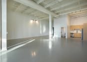Thumbnail 51 of 57 - a large empty room with white walls and concrete floors