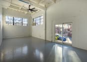 Thumbnail 52 of 57 - a large empty room with windows and a ceiling fan