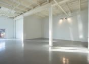 Thumbnail 53 of 57 - a large empty room with white walls and sunlight shining on the floor
