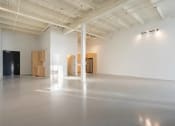 Thumbnail 54 of 57 - a large room with white walls and wood furniture