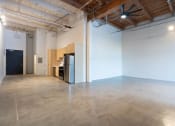 Thumbnail 55 of 57 - an empty room with a refrigerator in the middle of it