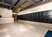 Thumbnail 22 of 24 - a large locker room in a gym with tile flooring and a white brick wall