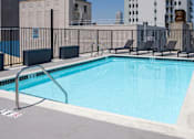 Thumbnail 16 of 24 - a view of a swimming pool with a city in the background