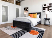 Thumbnail 8 of 24 - a bedroom with a bed and a rug