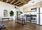 Thumbnail 2 of 24 - a kitchen with stainless steel appliances and a table