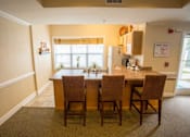 Thumbnail 12 of 32 - A kitchen with a table and chairs.