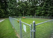 Thumbnail 26 of 32 - A chain link fence with a sign attached to it.