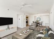Thumbnail 2 of 52 - A living room with a grey couch and a coffee table.