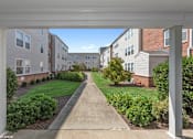 Thumbnail 41 of 52 - A view of a residential area with apartment buildings and a pathway.